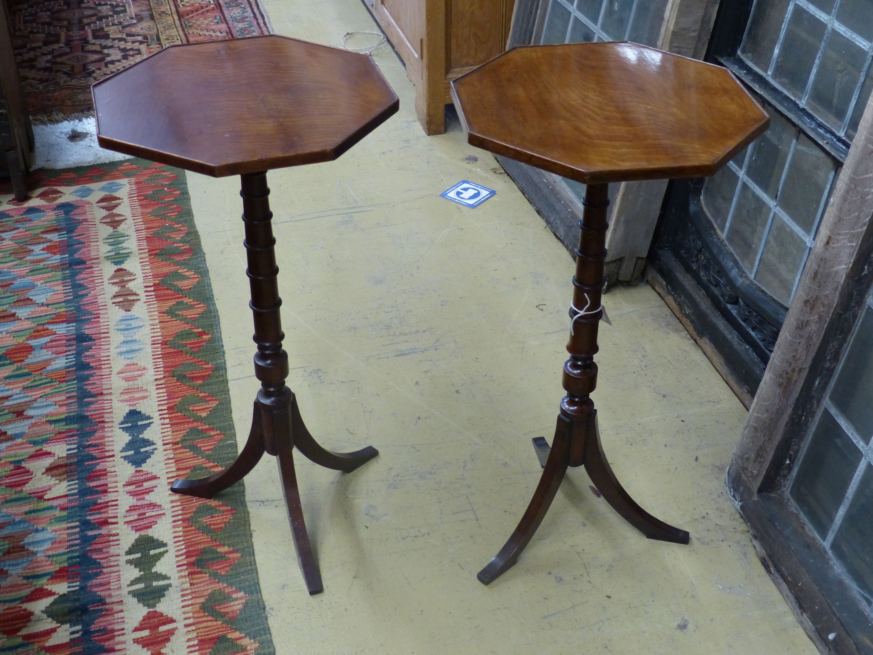 A pair of Regency style mahogany octagonal wine tables